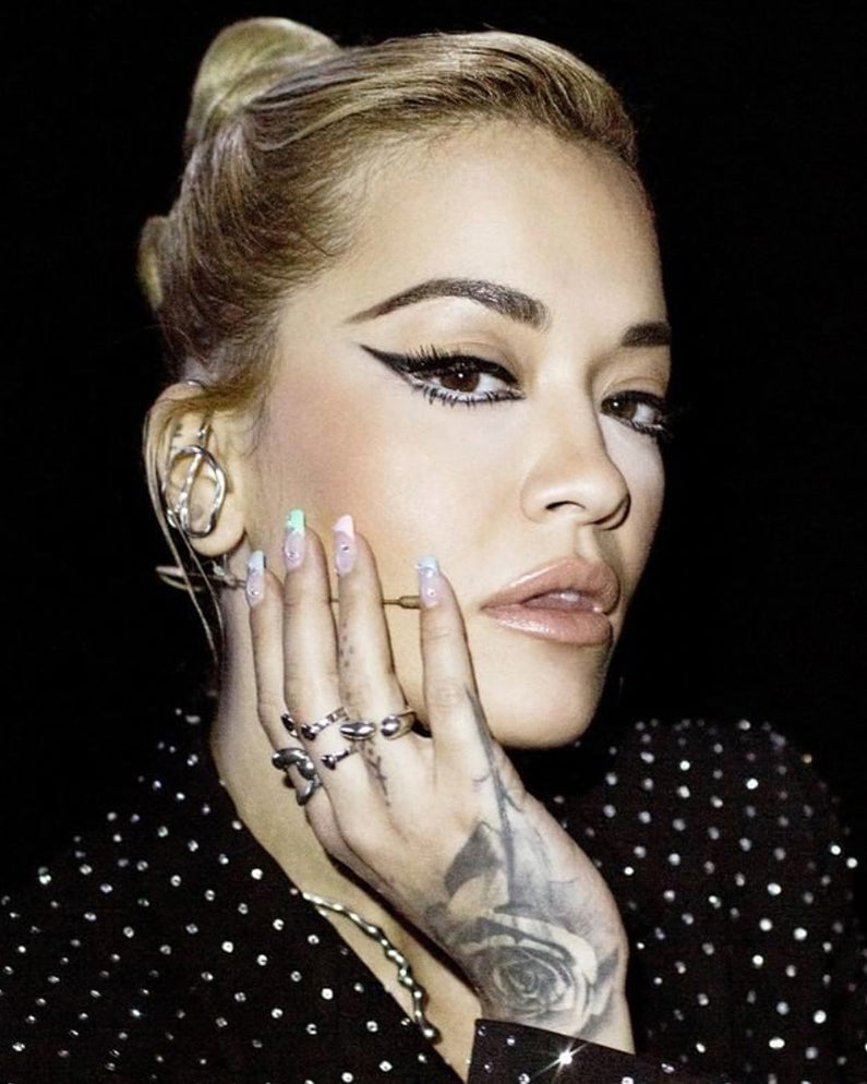 Rita Ora is wearing Poem Necklace, Hope Core Ring, Hope Double Ring, Hope Open Ring, Flux Ring, Hope Triple Hoop Ear Cuff, Flux Ear Cuff