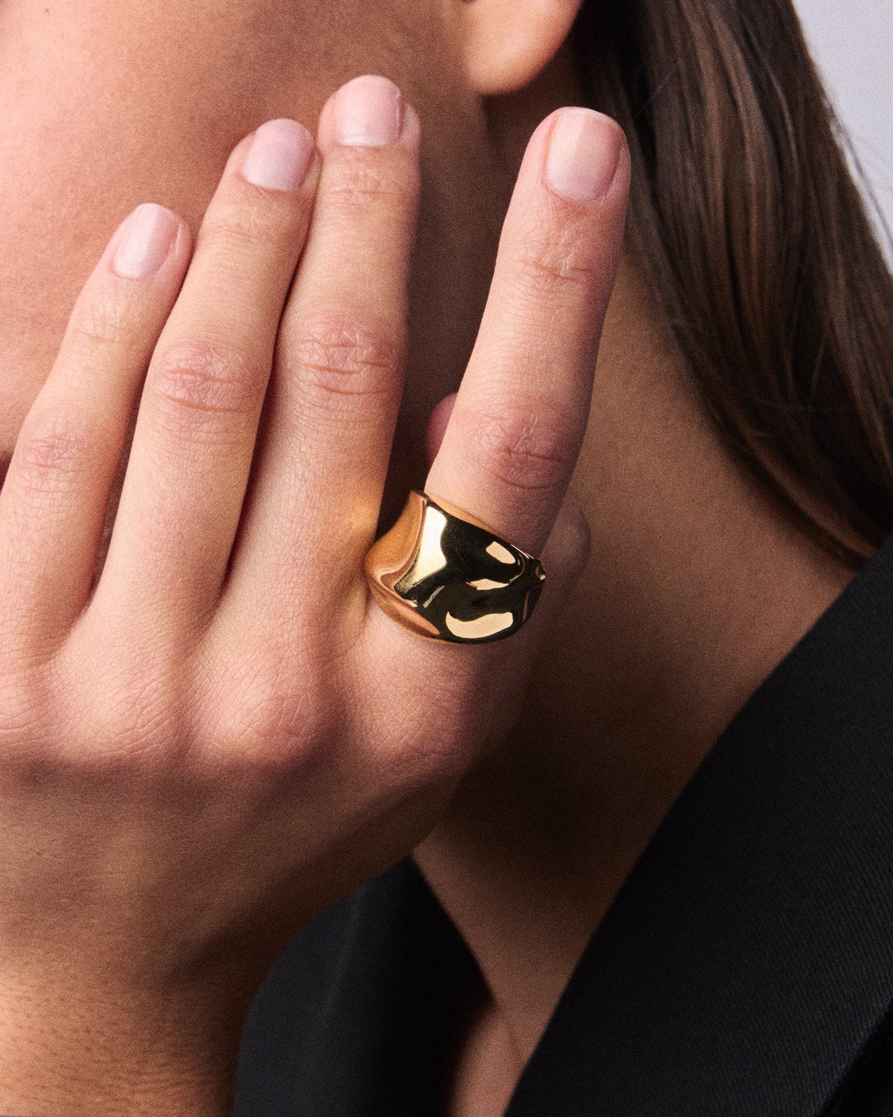 Curvy and unique gold vermeil dome ring, worn on a person’s index finger
