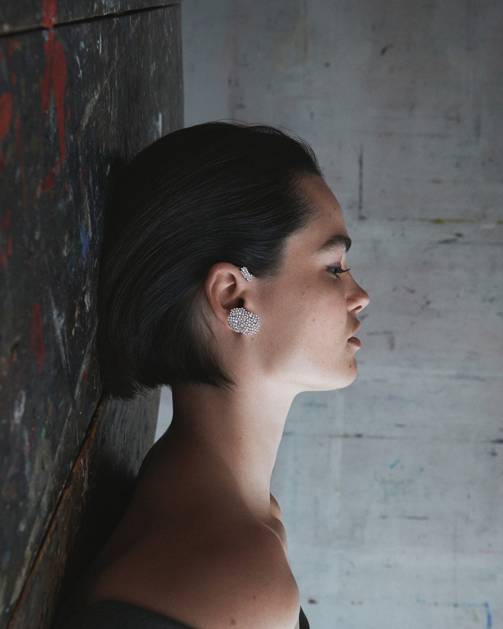 Elegant yet bold white gold ear cuff adorned with diamonds, a unique piece of sculptural jewelry