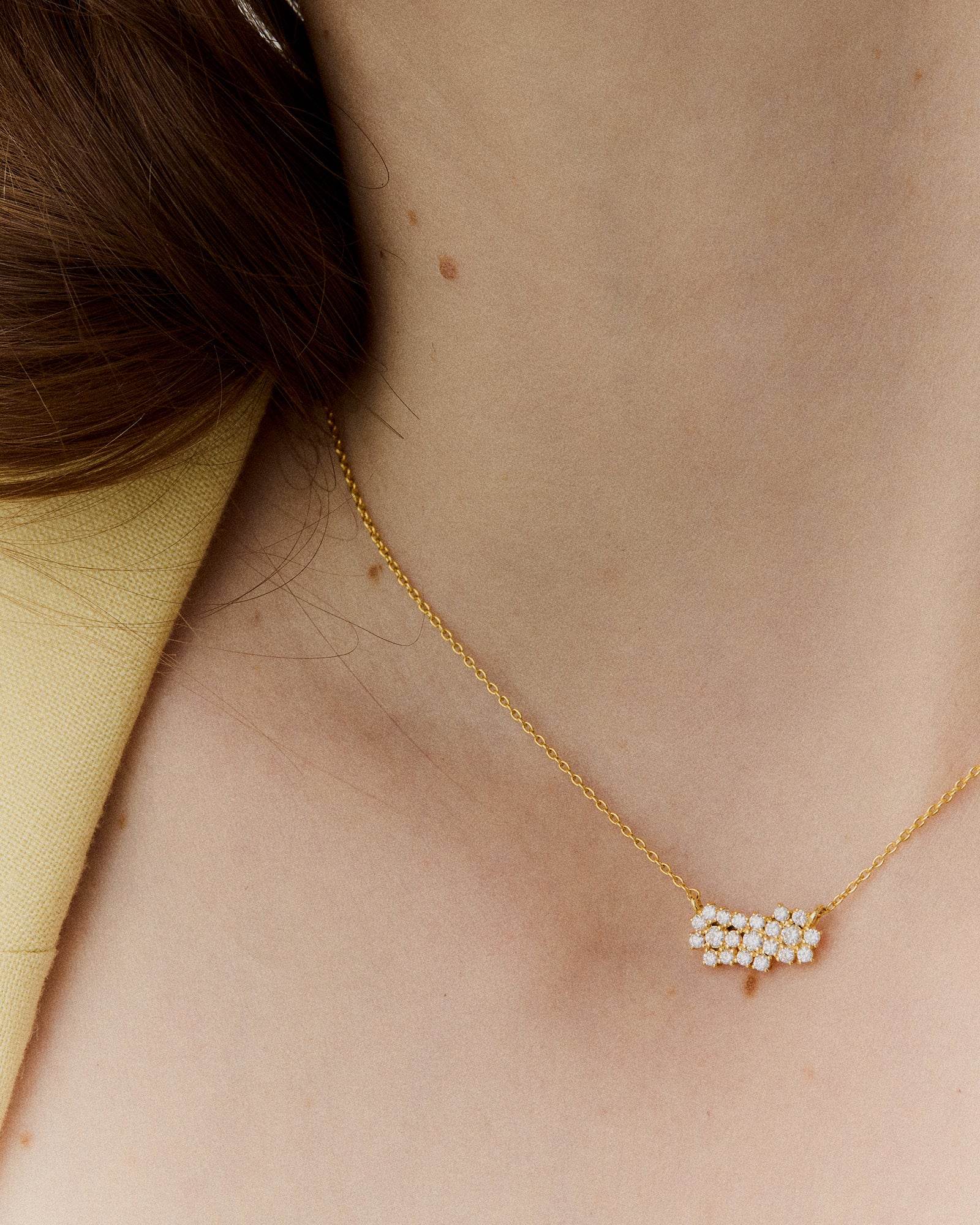 Detailed view of a gold necklace with unique diamond pendant design